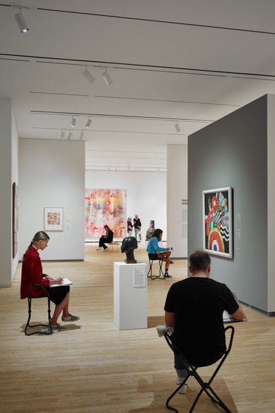 Interior view of art and students at the University of Iowa Stanley Museum of Art.