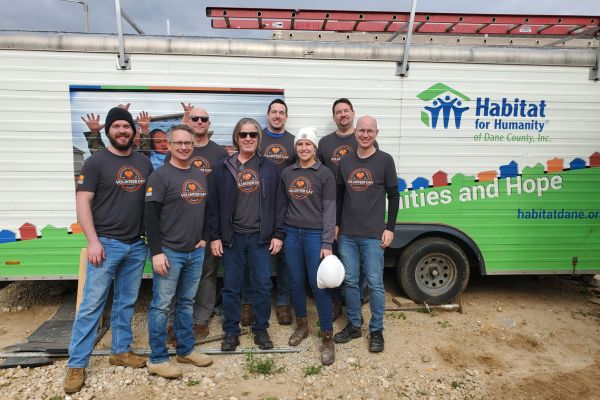 Design Engineers day three volunteers from Madison Wisconsin standing in front of the Habitat for Humanity of Dane County house.