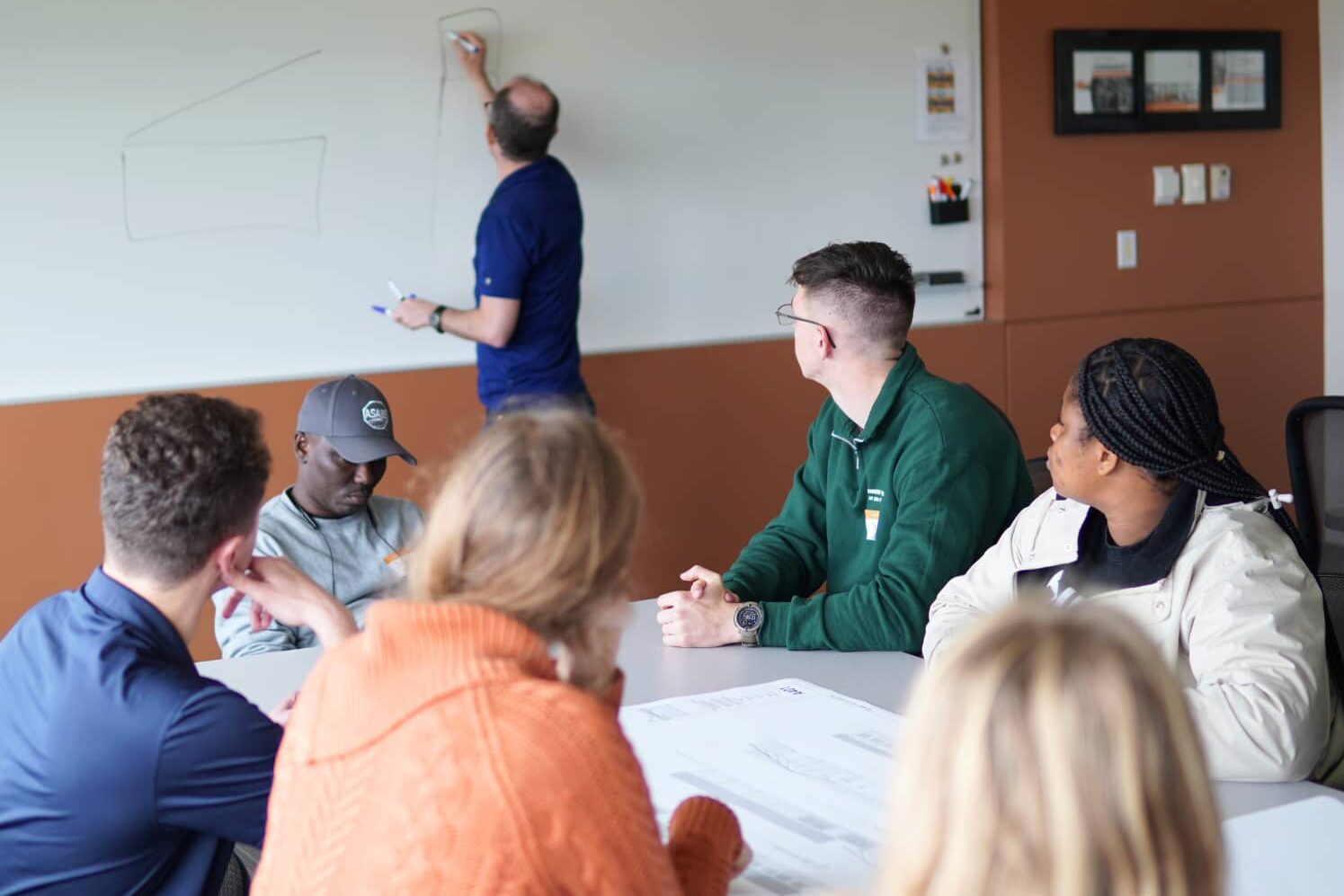 Senior Mechanical Engineer Tim Lentz leads a discussion with students from the Engineers Without Borders Chapter at Iowa State University and Kwame Nkrumah University of Science and Technology at Design Engineers.