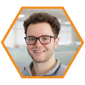 Headshot of Mechanical Engineer Sam Stinson in an orange hexagon frame.