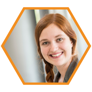 Headshot of Mechanical Engineer Darrow Center in an orange hexagon frame.