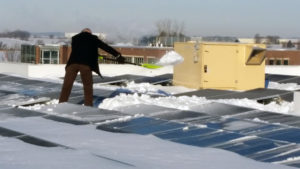 Dwight clears the snow from the rooftop PV Array.